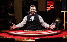 Close-up of live dealer handling cards at blackjack table